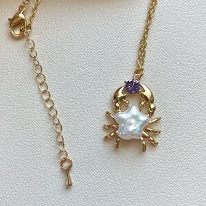 Gold Crab Pendant Necklace with Pearl and Purple Gem